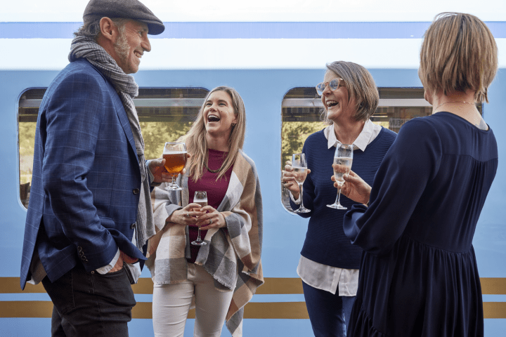 a group of people holding wine glasses