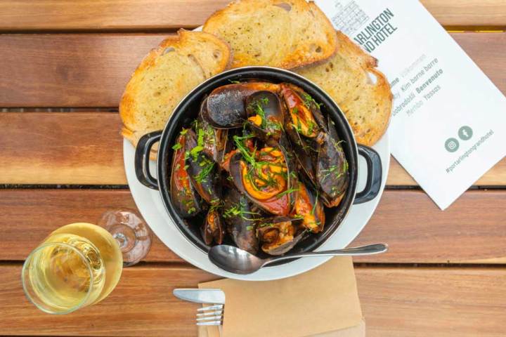 a plate of food sitting on top of a wooden table